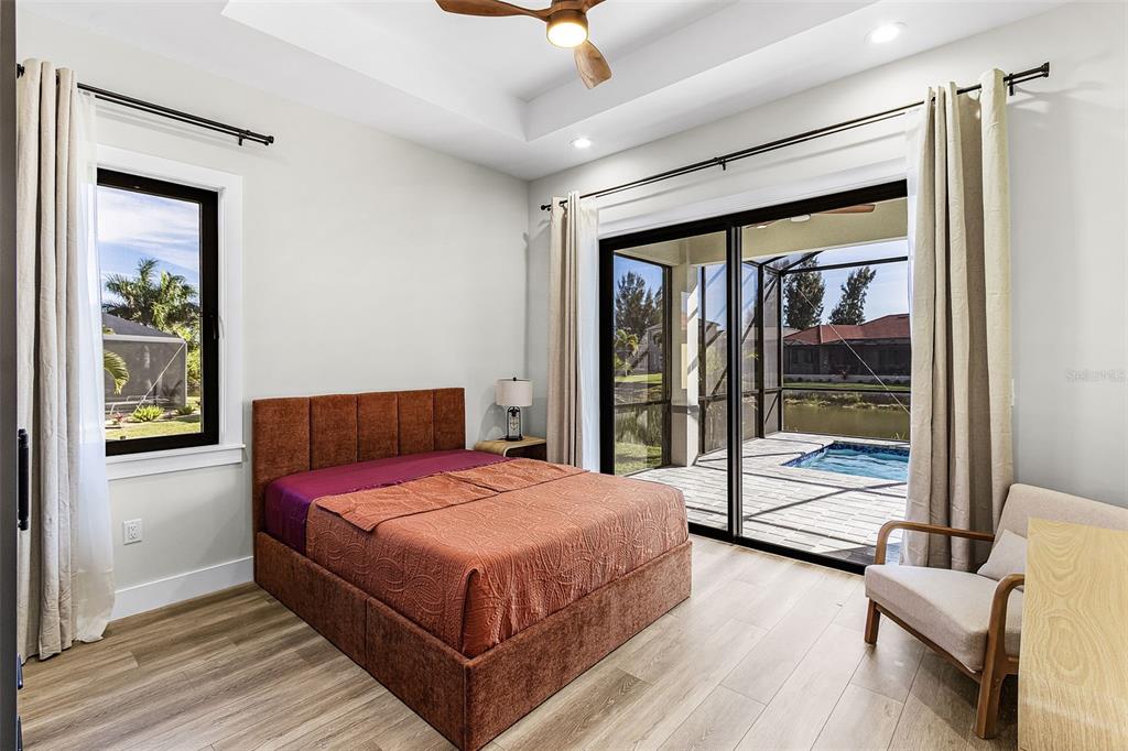 Atenia secondary bedroom with bed, window and lanai door