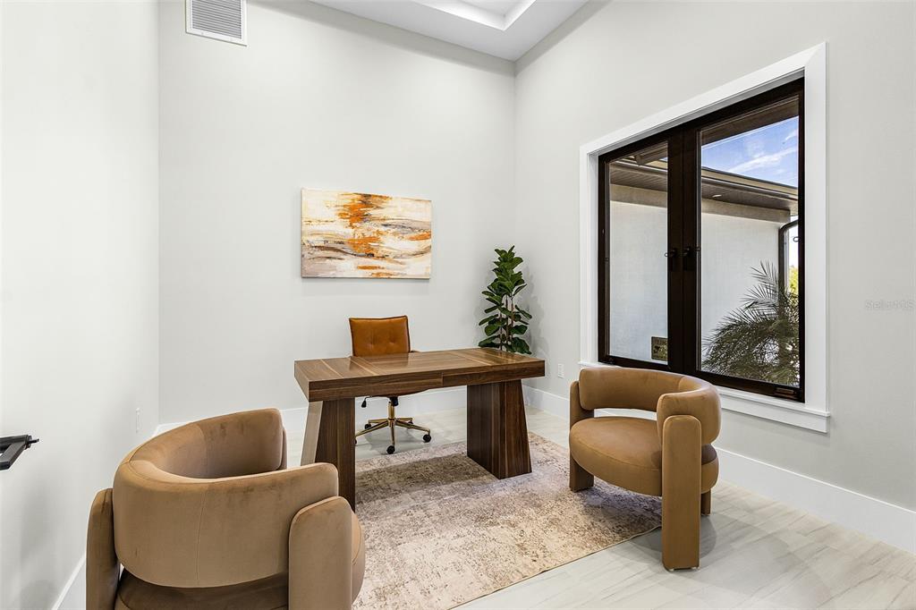 Atenia office or fourth bedroom with two chairs, wall art and window