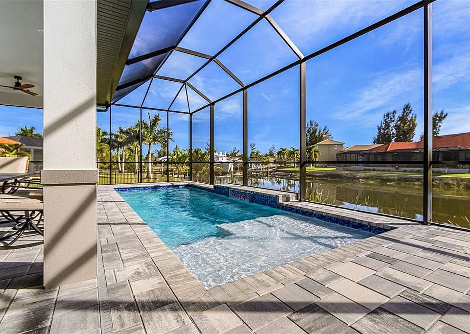 Atenia pool and screened lanai looking over the canal