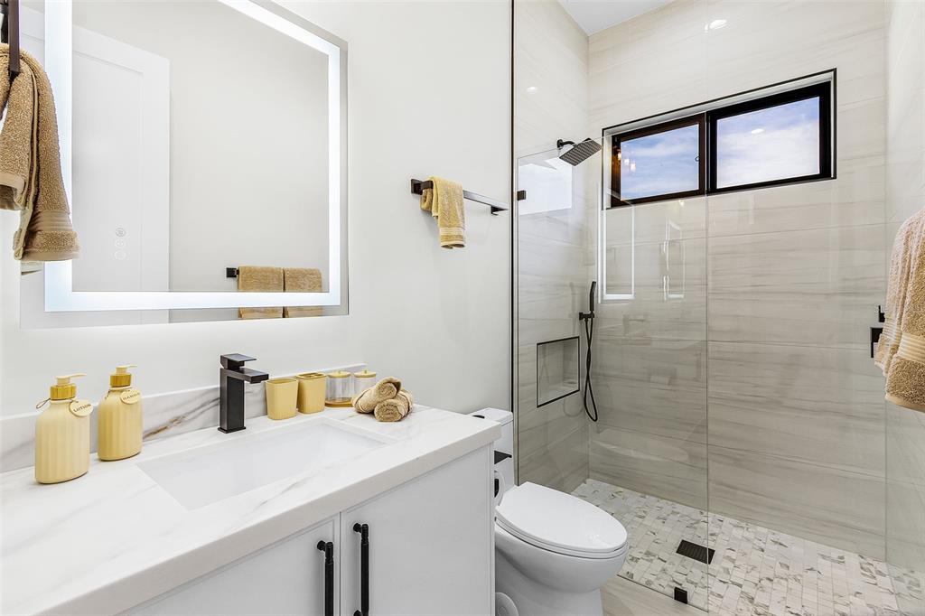 Atenia bathroom vanity, toilet and tiled shower